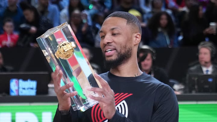 Feb 18, 2023; Salt Lake City, UT, USA; Portland Trail Blazers guard Damian Lillard (0) celebrates with the trophy after winning the 3-Point Contest during the 2023 All Star Saturday Night at Vivint Arena. Mandatory Credit: Kyle Terada-Imagn Images