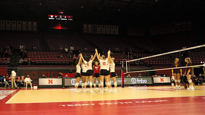 Nebraska huddles before taking on Minnesota at a near-empty Devaney Center during the spring 2021 season. The Huskers played matches in an empty Devaney Center in a season that was delayed by the COVID-19 pandemic. 