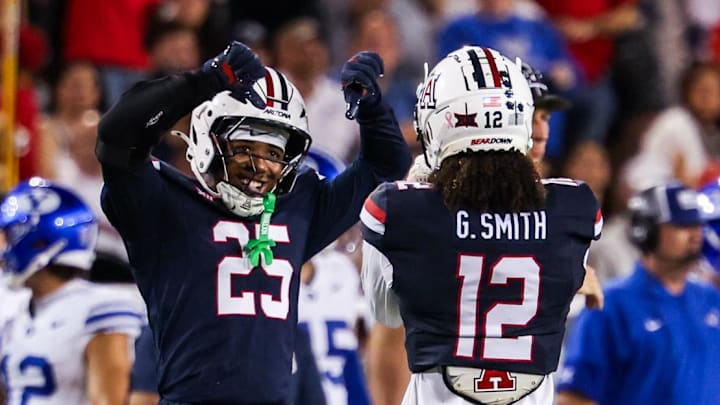 Oct 11, 2025; Tucson, Arizona, USA; Arizona Wildcats defensive backs Michael Dansby (25) and Genesis Smith (12) both celebrate during the fourth quarter of the game against the Brigham Young Cougars at Arizona Stadium. Mandatory Credit: Aryanna Frank-Imagn Images