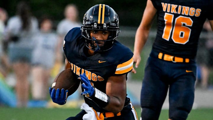 Haslett's Kory Amachree runs for a gain against DeWitt during the second quarter on Thursday, Aug. 29, 2024, at Haslett High School.