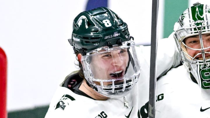 Michigan State's Maxim Strbak, left, and goalie Trey Augustine celebrate after bearing Ohio State in the Big Ten tournament game on Saturday, March 16, 2024, at Munn Arena in East Lansing.