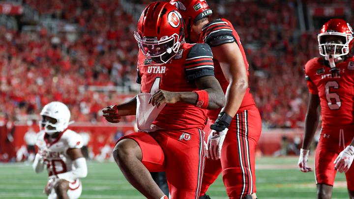 Utah Utes quarterback Devon Dampier (4) celebrates scoring a touchdown against the Arkansas Razorbacks during the second half at Rice-Eccles Stadium. Utah Utes quarterback Devon Dampier (4) celebrates scoring a touchdown against the Arkansas Razorbacks during the second half at Rice-Eccles Stadium.