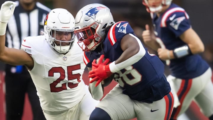 Dec 15, 2024; Glendale, Arizona, USA; New England Patriots running back Rhamondre Stevenson (38) against Arizona Cardinals linebacker Zaven Collins (25) at State Farm Stadium. Mandatory Credit: Mark J. Rebilas-Imagn Images
