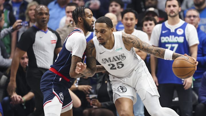 Dec 19, 2024; Dallas, Texas, USA;  Dallas Mavericks forward P.J. Washington (25) dribbles as LA Clippers forward Derrick Jones Jr. (55) defends during the first quarter at American Airlines Center. Mandatory Credit: Kevin Jairaj-Imagn Images