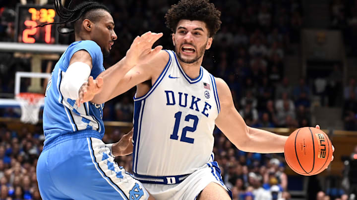 Mar 7, 2026; Durham, North Carolina, USA;Duke Blue Devils forward Cameron Boozer (12) drives to the basket as North Carolina Tar Heels forward Jarin Stevenson (15) defends during the second half at Cameron Indoor Stadium. The Duke Blue Devils won 76-61. Mandatory Credit: Rob Kinnan-Imagn Images Mar 7, 2026; Durham, North Carolina, USA;Duke Blue Devils forward Cameron Boozer (12) drives to the basket as North Carolina Tar Heels forward Jarin Stevenson (15) defends during the second half at Cameron Indoor Stadium. The Duke Blue Devils won 76-61. Mandatory Credit: Rob Kinnan-Imagn Images