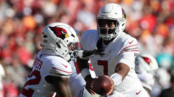 Nov 30, 2025; Tampa, Florida, USA; Arizona Cardinals quarterback Jacoby Brissett (7) hands off to running back Michael Carter (22) during the second half against the Tampa Bay Buccaneers at Raymond James Stadium. Mandatory Credit: Nathan Ray Seebeck-Imagn Images Nov 30, 2025; Tampa, Florida, USA; Arizona Cardinals quarterback Jacoby Brissett (7) hands off to running back Michael Carter (22) during the second half against the Tampa Bay Buccaneers at Raymond James Stadium. Mandatory Credit: Nathan Ray Seebeck-Imagn Images