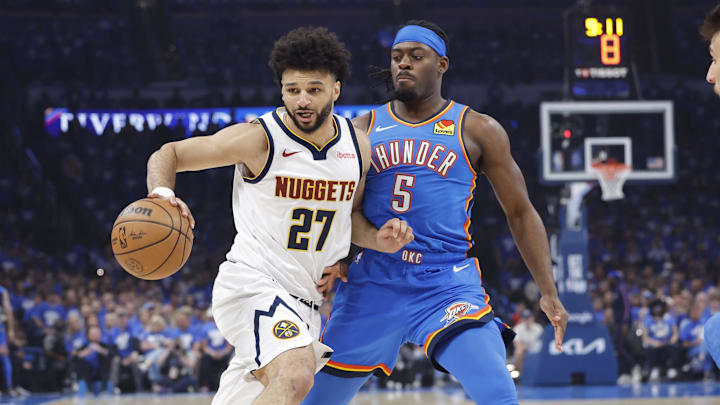 Denver guard Jamal Murray moves the ball down the court against Oklahoma City guard Luguentz Dort in a playoff game last season.