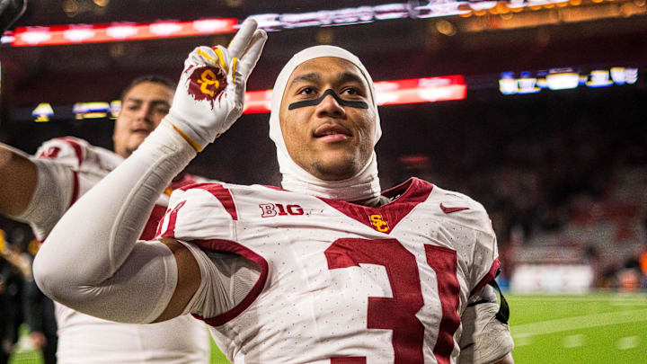 Nov 1, 2025; Lincoln, Nebraska, USA; Southern California Trojans linebacker Jadyn Walker (31) and offensive lineman Elijah Paige (72) hold up a “V” to fans after defeating the Nebraska Cornhuskers at Memorial Stadium. Mandatory Credit: Dylan Widger-Imagn Images
