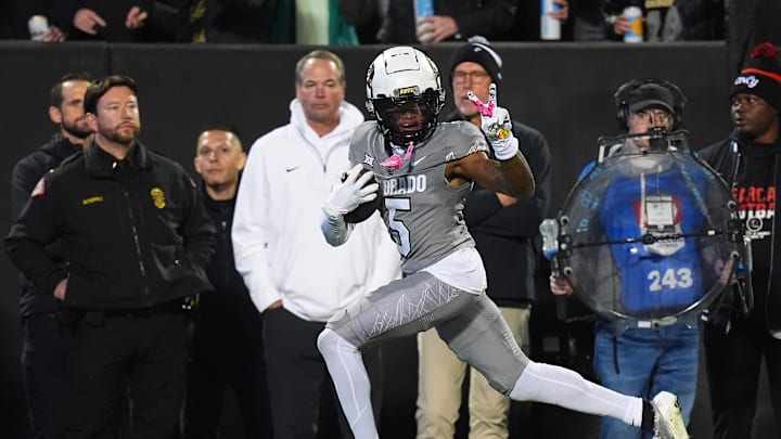 Oct 26, 2024; Boulder, Colorado, USA; Colorado Buffaloes wide receiver Jimmy Horn Jr. (5) signals a peace sign to Cincinnati Bearcats defensive back Josh Minkins (0) and is called for taunting penalty in the first quarter at Folsom Field. Mandatory Credit: Ron Chenoy-Imagn Images