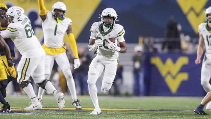 Nov 16, 2024; Morgantown, West Virginia, USA; Baylor Bears running back Bryson Washington (30) runs the ball for a touchdown during the second quarter against the West Virginia Mountaineers at Mountaineer Field at Milan Puskar Stadium.