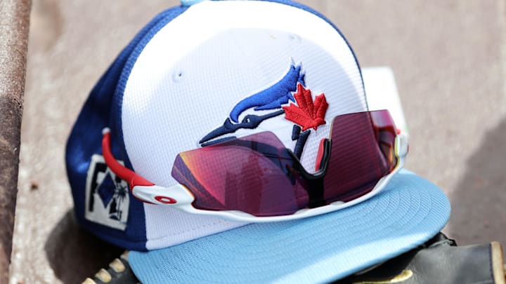 Mar 1, 2025; North Port, Florida, USA; A detail view of a Toronto Blue Jays hat , sunglasses and glove laying in the dugout against the Atlanta Braves at CoolToday Park. Mar 1, 2025; North Port, Florida, USA; A detail view of a Toronto Blue Jays hat , sunglasses and glove laying in the dugout against the Atlanta Braves at CoolToday Park.