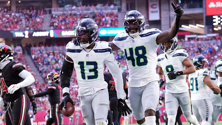 Dec 8, 2024; Glendale, Arizona, USA; Seattle Seahawks linebacker Ernest Jones IV (13) celebrates an interception against the Arizona Cardinals during the first half at State Farm Stadium. Mandatory Credit: Joe Camporeale-Imagn Images