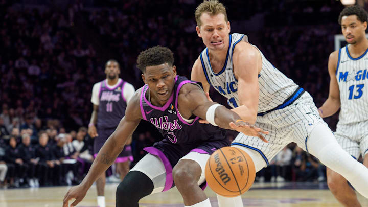 Mar 7, 2026; Minneapolis, Minnesota, USA; Minnesota Timberwolves guard Anthony Edwards (5) and Orlando Magic forward Moritz Wagner (21) play a loose ball in the third quarter at Target Center. Mandatory Credit: Matt Blewett-Imagn Images