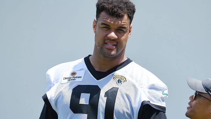 Jaguars director of football communications Dylan Morton talks with Jacksonville Jaguars defensive tackle Arik Armstead (91) at the end of the organized team activity session Monday, June 3, 2024 at EverBank Stadium's Miller Electric Center in Jacksonville, Fla.