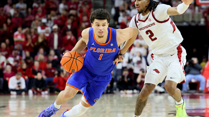 Florida Gators guard Walter Clayton Jr. (1) drives against Arkansas Razorbacks guard Boogie Fland. Florida Gators guard Walter Clayton Jr. (1) drives against Arkansas Razorbacks guard Boogie Fland.
