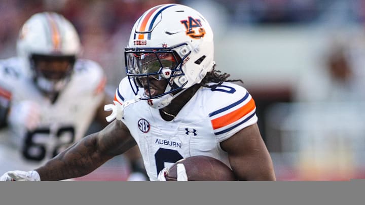 Nov 30, 2024; Tuscaloosa, Alabama, USA; Auburn Tigers running back Damari Alston (0) carries the ball against Alabama Crimson Tide defensive back Domani Jackson (1) during the first quarter at Bryant-Denny Stadium. Mandatory Credit: Will McLelland-Imagn Images Nov 30, 2024; Tuscaloosa, Alabama, USA; Auburn Tigers running back Damari Alston (0) carries the ball against Alabama Crimson Tide defensive back Domani Jackson (1) during the first quarter at Bryant-Denny Stadium. Mandatory Credit: Will McLelland-Imagn Images