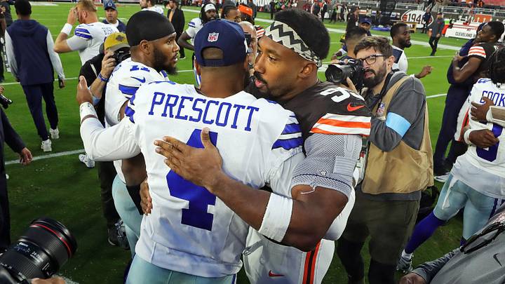 Cleveland Browns defensive end Myles Garrett hugs Dallas Cowboys quarterback Dak Prescott after a game at Huntington Bank Field
