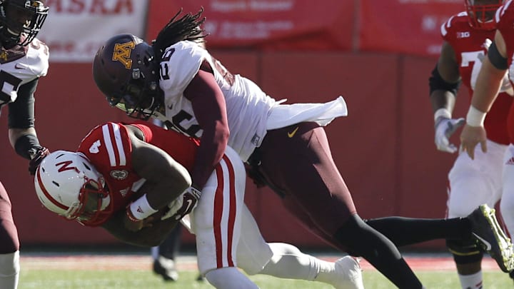 Nov 22, 2014; Lincoln, NE, USA; Minnesota Golden Gophers defender De'Vondre Campbell (26) tackles Nebraska Cornhuskers quarterback Tommy Armstrong Jr. (4) in the second half at Memorial Stadium. Minnesota won 28-24. Mandatory Credit: Bruce Thorson-Imagn Images Nov 22, 2014; Lincoln, NE, USA; Minnesota Golden Gophers defender De'Vondre Campbell (26) tackles Nebraska Cornhuskers quarterback Tommy Armstrong Jr. (4) in the second half at Memorial Stadium. Minnesota won 28-24. Mandatory Credit: Bruce Thorson-Imagn Images