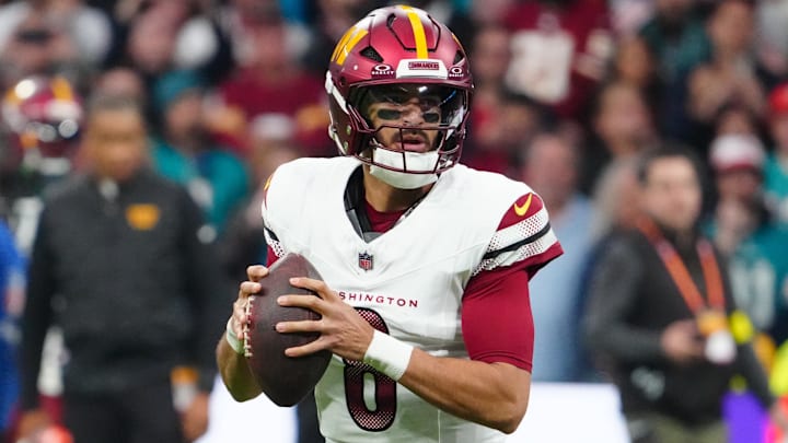 Nov 16, 2025; Madrid, Spain; Washington Commanders quarterback Marcus Mariota (8) looks to pass the ball against the Miami Dolphins in the first quarter during the 2025 NFL Madrid Game at Santiago Bernabeu Stadium. 