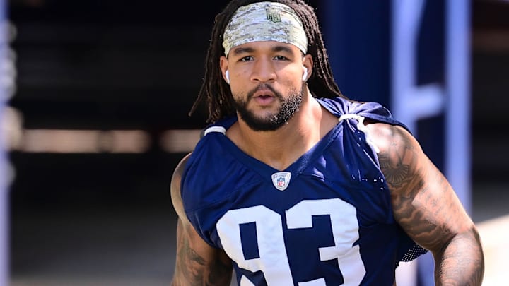 Former New England Patriots linebacker Oshane Ximines (93) walks to the practice fields for minicamp at Gillette Stadium.