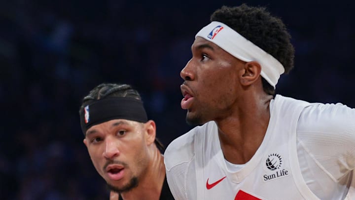 Toronto Raptors guard Ja'kobe Walter goes to the basket against New York Knicks guard Josh Hart. Toronto Raptors guard Ja'kobe Walter goes to the basket against New York Knicks guard Josh Hart.