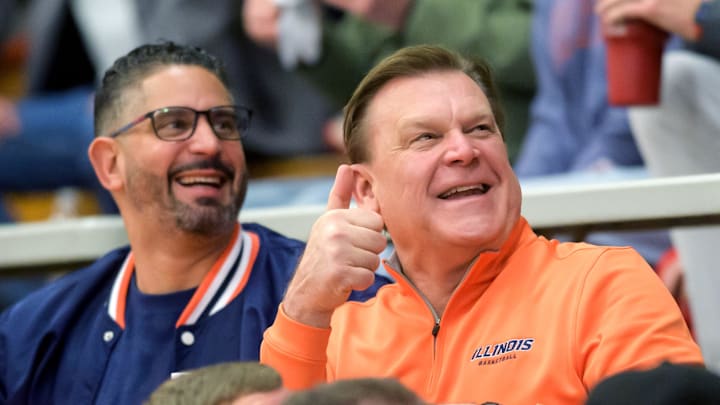 Illini head coach Brad Underwood, in orange, and associate head coach Orlando Antigua greets fans at the Class 3A Washington Sectional semifinal Tuesday, March 4, 2025 at Washington Community High School. The Redbirds' rallied to defeat Kankakee 65-63 in overtime.