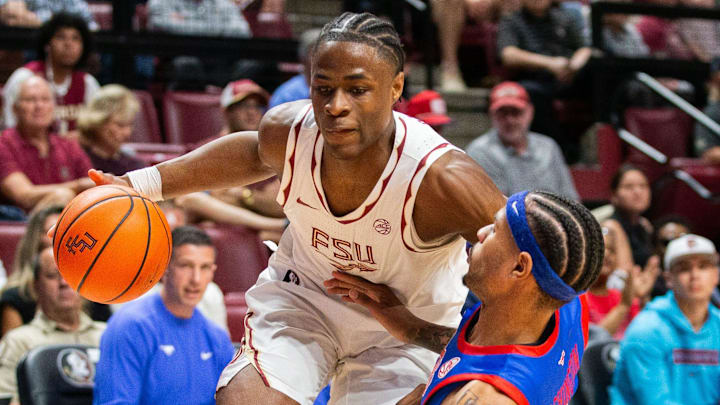 Florida State Seminoles guard Thomas Bassong (3) knocks a defender to the ground while driving the ball to the hoop. The Florida State Seminoles hosted the Southern Methodist University Mustangs at the Tucker Civic Center on Saturday, March 7, 2026.
