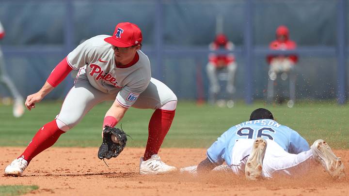 Feb 25, 2025; Port Charlotte, Florida, USA;  Tampa Bay Rays outfielder Chandler Simpson (96) slides safely into second base against Philadelphia Phillies infielder Aidan Miller (81) at Charlotte Sports Park.