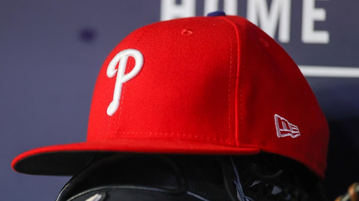 May 26, 2023; Atlanta, Georgia, USA; A detailed view of a Philadelphia Phillies hat and glove on the bench against the Atlanta Braves in the seventh inning at Truist Park.