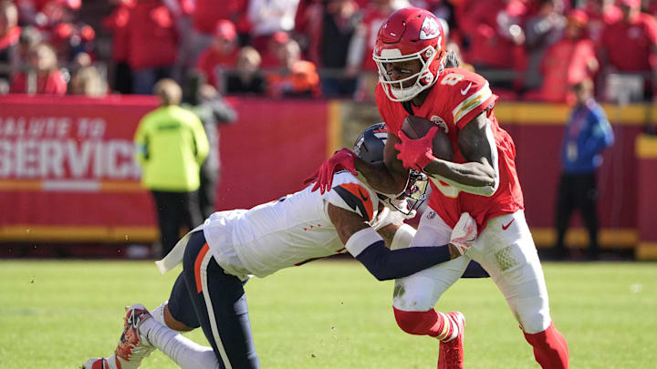 Nov 10, 2024; Kansas City, Missouri, USA; Kansas City Chiefs wide receiver DeAndre Hopkins (8) catches a pass as Denver Broncos cornerback Pat Surtain II (2) attempts the tackle during the first half at GEHA Field at Arrowhead Stadium. Mandatory Credit: Denny Medley-Imagn Images