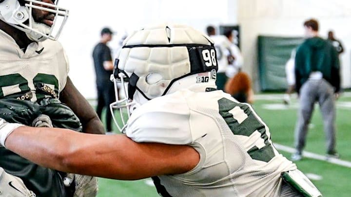 Michigan State's Derrick Simmons, right, and Quindarius Dunnigan work out with the defensive line during football practice on Tuesday, April 8, 2025, in East Lansing.