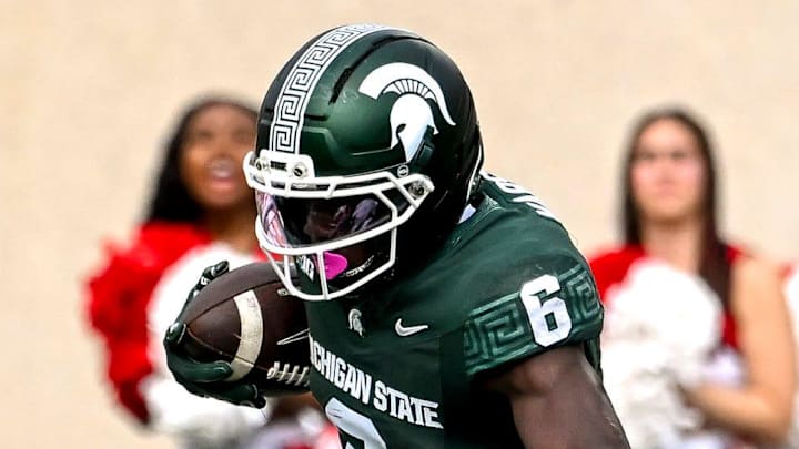 Michigan State's Nick Marsh, left, spins off a tackle attempt by Youngstown State's Justin Wimpye during the second quarter on Saturday, Sept. 13, 2025, at Spartan Stadium in East Lansing.