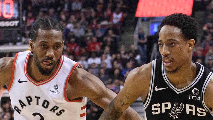 San Antonio Spurs guard DeMar DeRozan controls a ball as Toronto Raptors forward Kawhi Leonard tries to defend. San Antonio Spurs guard DeMar DeRozan controls a ball as Toronto Raptors forward Kawhi Leonard tries to defend.