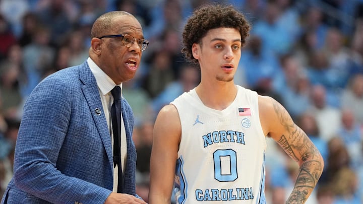 Feb 28, 2026; Chapel Hill, North Carolina, USA; North Carolina Tar Heels head coach Hubert Davis with guard Kyan Evans (0) in the second half at Dean E. Smith Center. Mandatory Credit: Bob Donnan-Imagn Images