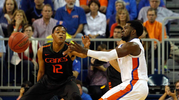 Nov 17, 2014; Gainesville, FL, USA; Florida Gators guard Eli Carter (1) passes the ball as Miami (Fl) Hurricanes guard James Palmer (12) defends during the second half at Stephen C. O'Connell Center. Miami (Fl) Hurricanes defeated the Florida Gators 69-67. Mandatory Credit: Kim Klement-Imagn Images Nov 17, 2014; Gainesville, FL, USA; Florida Gators guard Eli Carter (1) passes the ball as Miami (Fl) Hurricanes guard James Palmer (12) defends during the second half at Stephen C. O'Connell Center. Miami (Fl) Hurricanes defeated the Florida Gators 69-67. Mandatory Credit: Kim Klement-Imagn Images