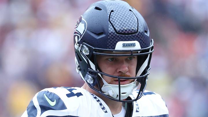 Seattle Seahawks quarterback Sam Darnold practices on the sideline in the first quarter against the Washington Commanders.