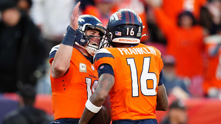 Nov 17, 2024; Denver, Colorado, USA; Denver Broncos wide receiver Troy Franklin (16) celebrates his touchdown with quarterback Bo Nix (10) in the second half against the Atlanta Falcons at Empower Field at Mile High. 