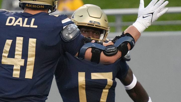 University of Akron defensive lineman Bruno Dall (41) congratulates defensive back Malcolm DeWalt IV (17)