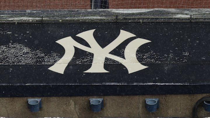 Aug 17, 2020; Bronx, New York, USA; A general view of rain falling on the  New York Yankees logo on the first base dugout roof during a rain delay in the game between the New York Yankees and the Boston Red Sox. Mandatory Credit: Vincent Carchietta-Imagn Images
