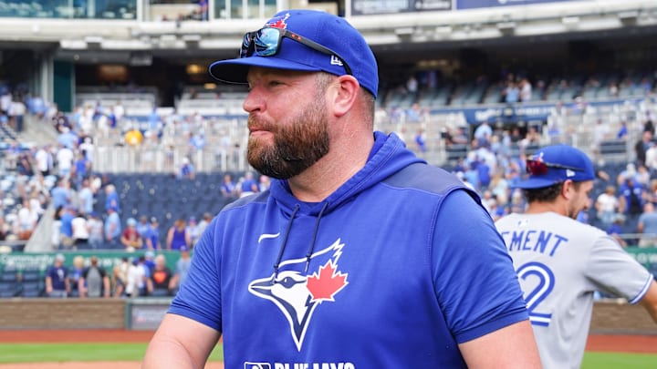 Sep 21, 2025; Kansas City, Missouri, USA; Toronto Blue Jays manager John Schneider (14) congratulates players on field after the win over the Kansas City Royals at Kauffman Stadium