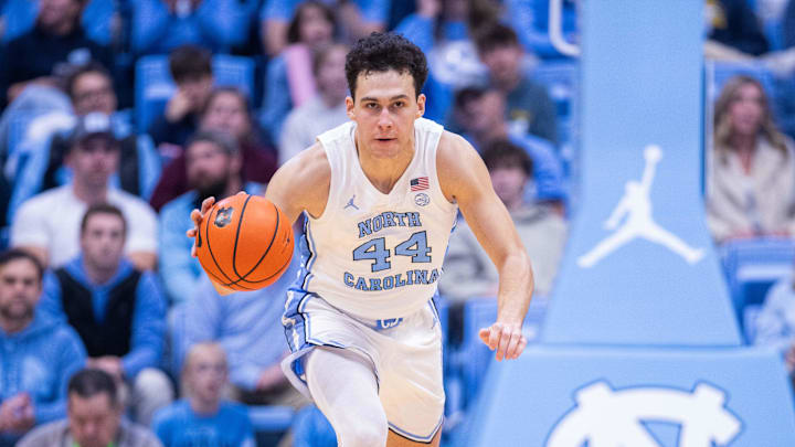 Nov 18, 2025; Chapel Hill, North Carolina, USA; North Carolina Tar Heels guard Luka Bogavac (44) brings the ball up court against the Navy Midshipmen during the second half at Dean E. Smith Center. Mandatory Credit: Scott Kinser-Imagn Images Nov 18, 2025; Chapel Hill, North Carolina, USA; North Carolina Tar Heels guard Luka Bogavac (44) brings the ball up court against the Navy Midshipmen during the second half at Dean E. Smith Center. Mandatory Credit: Scott Kinser-Imagn Images