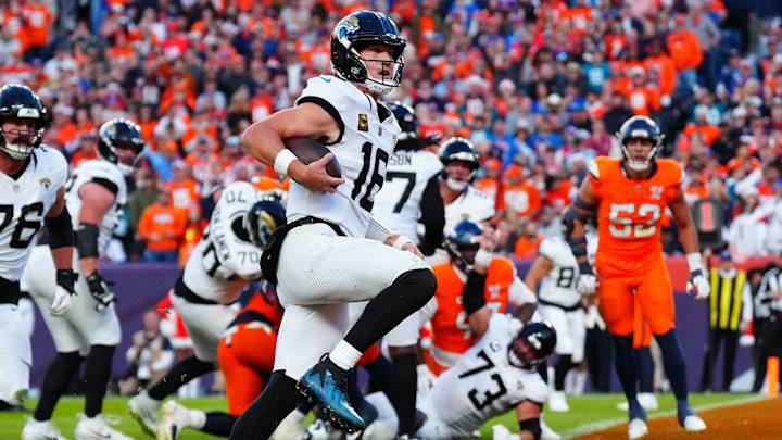 Dec 21, 2025; Denver, Colorado, USA; Jacksonville Jaguars quarterback Trevor Lawrence (16) rushes for a touchdown against the Denver Broncos during the second at Empower Field at Mile High.