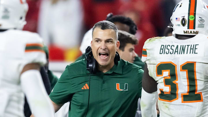 Jan 19, 2026; Miami Gardens, FL, USA; Miami Hurricanes head coach Mario Cristobal with linebacker Wesley Bissainthe (31) against the Indiana Hoosiers during the College Football Playoff National Championship game at Hard Rock Stadium. Mandatory Credit: Mark J. Rebilas-Imagn Images