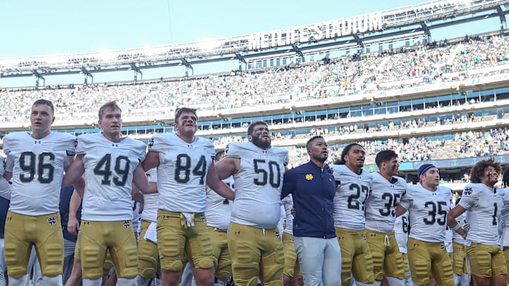 Oct 26, 2024; East Rutherford, New Jersey, USA; Notre Dame Fighting Irish head coach Marcus Freeman stands with his team for their alma mater after their game against the Navy Midshipmen at MetLife Stadium. 