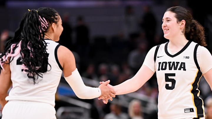 Mar 7, 2026; Indianapolis, IN, USA; Iowa Hawkeyes forward Hannah Stuelke (45) and Iowa Hawkeyes center Ava Heiden (5) high-five against the Michigan Wolverines during the second half at Gainbridge Fieldhouse. Mandatory Credit: Robert Goddin-Imagn Images