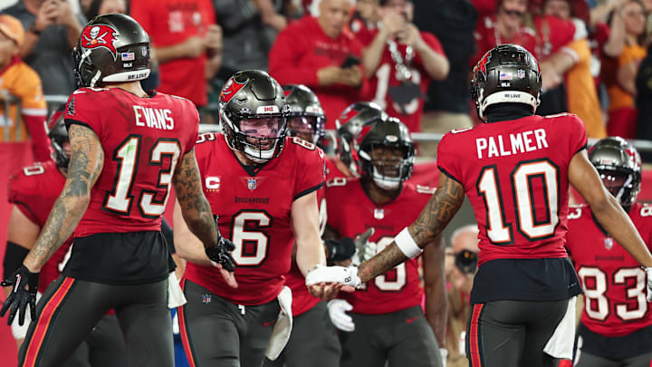 Jan 15, 2024; Tampa, Florida, USA;Tampa Bay Buccaneers quarterback Baker Mayfield (6) celebrates a touchdown with wide receivers Mike Evans (13) and Trey Palmer (10) against the Philadelphia Eagles during the first half of a 2024 NFC wild card game at Raymond James Stadium. Mandatory Credit: Kim Klement Neitzel-Imagn Images Jan 15, 2024; Tampa, Florida, USA;Tampa Bay Buccaneers quarterback Baker Mayfield (6) celebrates a touchdown with wide receivers Mike Evans (13) and Trey Palmer (10) against the Philadelphia Eagles during the first half of a 2024 NFC wild card game at Raymond James Stadium. Mandatory Credit: Kim Klement Neitzel-Imagn Images