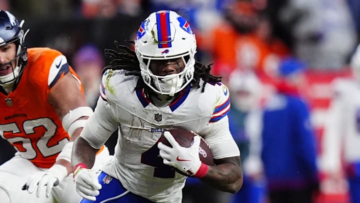 Jan 17, 2026; Denver, CO, USA; Buffalo Bills running back James Cook III (4) runs against Denver Broncos linebacker Jonah Elliss (52) and defensive end Eyioma Uwazurike (96) during the fourth quarter of an AFC Divisional Round playoff game at Empower Field at Mile High. Mandatory Credit: Ron Chenoy-Imagn Images