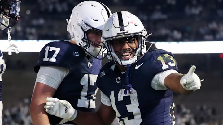 Nov 22, 2025; University Park, Pennsylvania, USA; Penn State Nittany Lions running back Kaytron Allen (13) celebrates with quarterback Ethan Grunkemeyer (17) after scoring a touchdown during the fourth quarter against the Nebraska Cornhuskers at Beaver Stadium. Mandatory Credit: Matthew O'Haren-Imagn Images