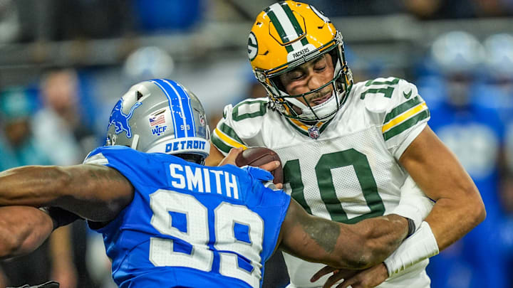 Green Bay Packers quarterback Jordan Love (10) is sacked by Detroit Lions defensive end Za'Darius Smith (99)