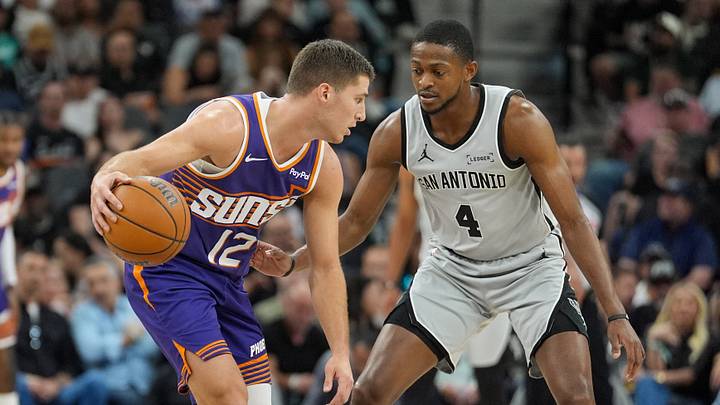 Mar 19, 2026; San Antonio, Texas, USA; Phoenix Suns guard Collin Gillespie (12) dribbles against San Antonio Spurs guard De'aaron Fox (4) in the first half at Frost Bank Center. Mandatory Credit: Daniel Dunn-Imagn Images Mar 19, 2026; San Antonio, Texas, USA; Phoenix Suns guard Collin Gillespie (12) dribbles against San Antonio Spurs guard De'aaron Fox (4) in the first half at Frost Bank Center. Mandatory Credit: Daniel Dunn-Imagn Images